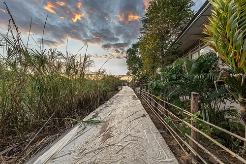 Giant tarpaulin covering a road under construction at sunrise with a colorful sky in Don Det, Si Phan Don, Laos.