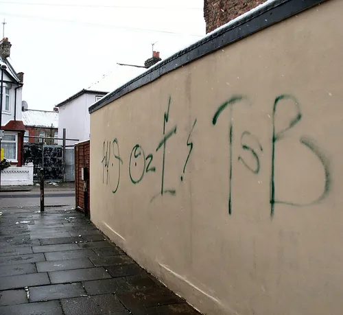 Tagging on the side wall of the alleyway leading from Dowsett Road N17 to Carew Road. The photo is taken looking northwards towards Dowsett 
